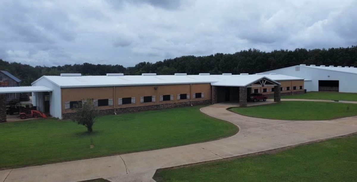 Long white commercial and equestrian building complex