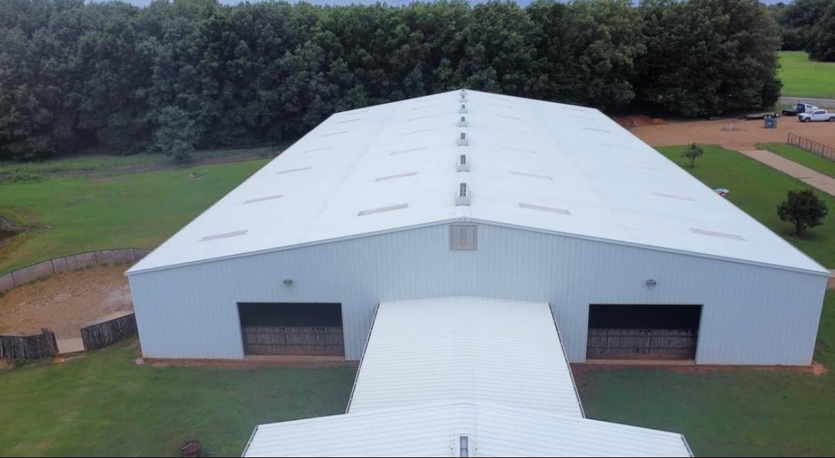 Drone view of the front of a white metal building